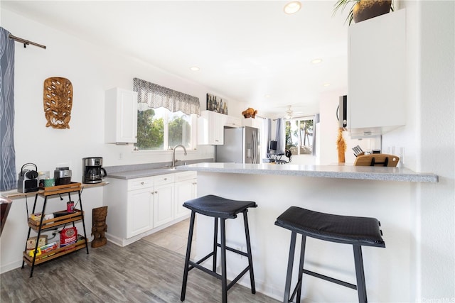 92-7049 Elele St Unit 29, Kapolei, HI 96707 - kitchen with stainless steel fridge, healthy amount of natural light, a peninsula, white cabinets, and recessed lighting
