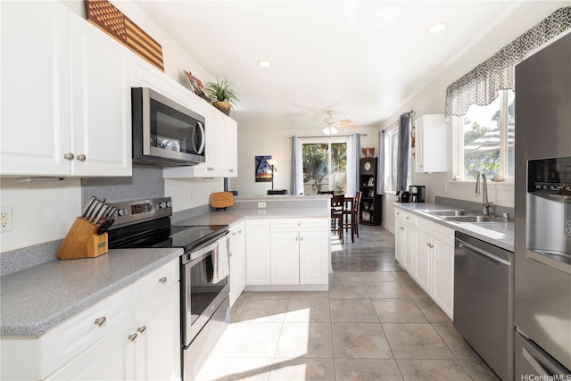 92-7049 Elele St Unit 29, Kapolei, HI 96707 - kitchen with appliances with stainless steel finishes, a sink, healthy amount of natural light, ceiling fan, and recessed lighting