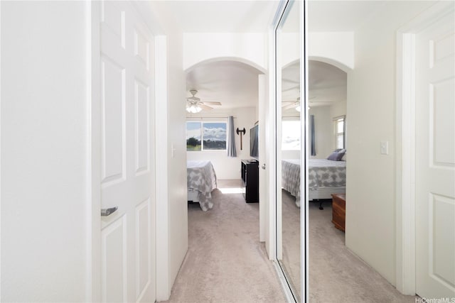 92-7049 Elele St Unit 29, Kapolei, HI 96707 - corridor with arched walkways, light carpet, and plenty of natural light
