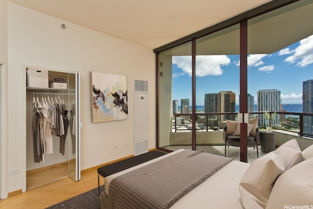725 Kapiolani Blvd Unit 2901, Honolulu, HI 96813 - bedroom with expansive windows, a view of city, wood finished floors, baseboards, and a closet