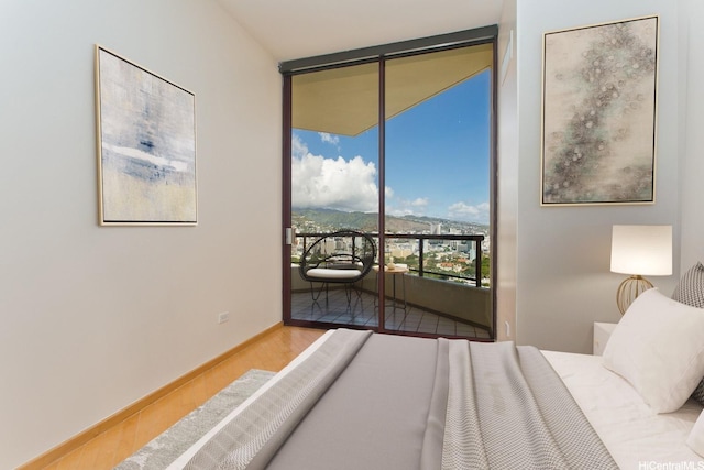 725 Kapiolani Blvd Unit 2901, Honolulu, HI 96813 - bedroom with wood finished floors, access to outside, a wall of windows, and baseboards