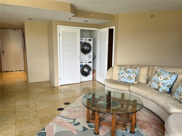 tiled living area featuring estacked washer and dryer