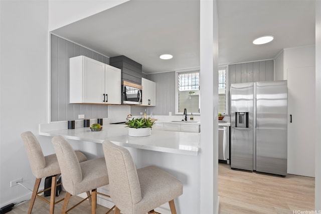 500 University Ave Unit Ph6, Honolulu, HI 96826 - kitchen with appliances with stainless steel finishes, a sink, a kitchen breakfast bar, and white cabinets