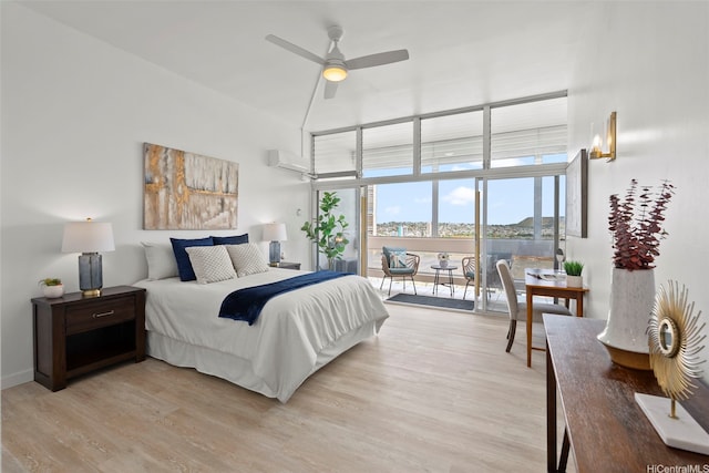 500 University Ave Unit Ph6, Honolulu, HI 96826 - bedroom with light wood-style floors, a towering ceiling, access to exterior, and a wall mounted air conditioner