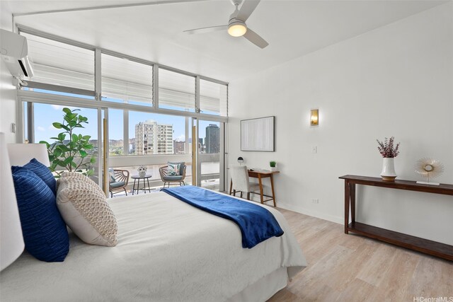 500 University Ave Unit Ph6, Honolulu, HI 96826 - bedroom featuring multiple windows, light wood-style flooring, a city view, and baseboards