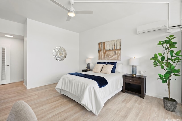500 University Ave Unit Ph6, Honolulu, HI 96826 - bedroom with an AC wall unit, light wood-type flooring, baseboards, and a ceiling fan