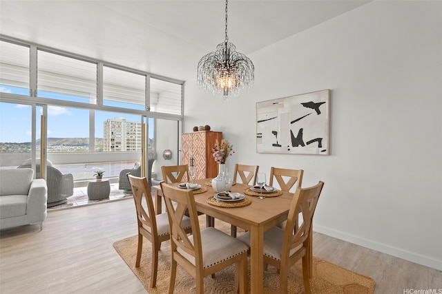 500 University Ave Unit Ph6, Honolulu, HI 96826 - dining room featuring a chandelier, light wood-style floors, and baseboards