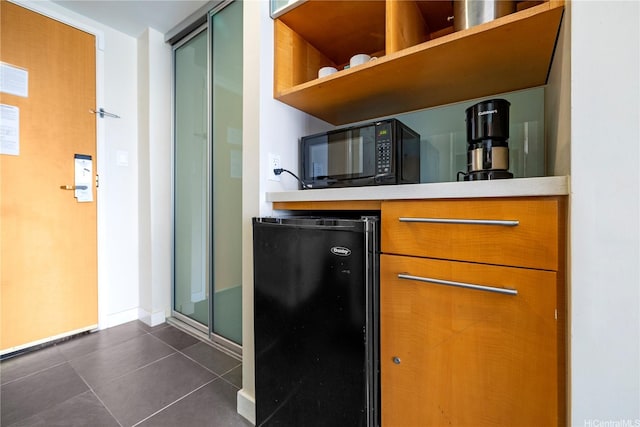 410 Atkinson Dr Unit 1616, Honolulu, HI 96814 - kitchen featuring black microwave, fridge, dark tile patterned floors, light countertops, and baseboards