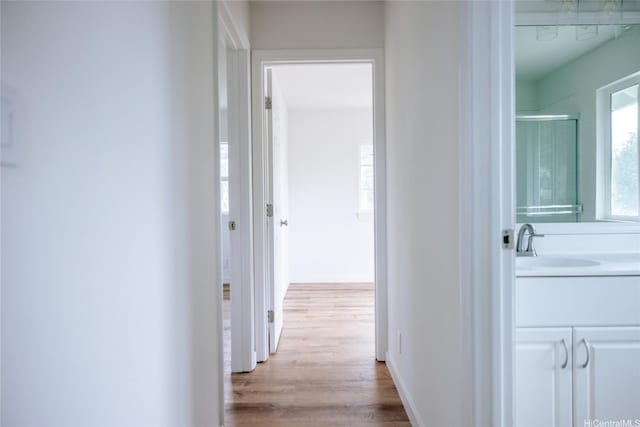 87-1026 Nenewai St, Waianae, HI 96792 - corridor with a sink and wood finished floors