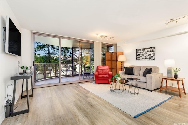 425 S St Unit 403, Honolulu, HI 96813 - living area featuring rail lighting, wood finished floors, a wall of windows, and baseboards