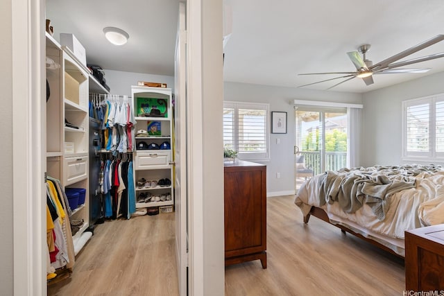 bedroom with light wood-type flooring, access to outside, a closet, a ceiling fan, and baseboards