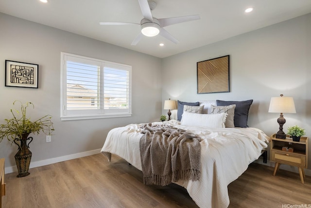bedroom with wood finished floors, recessed lighting, baseboards, and ceiling fan
