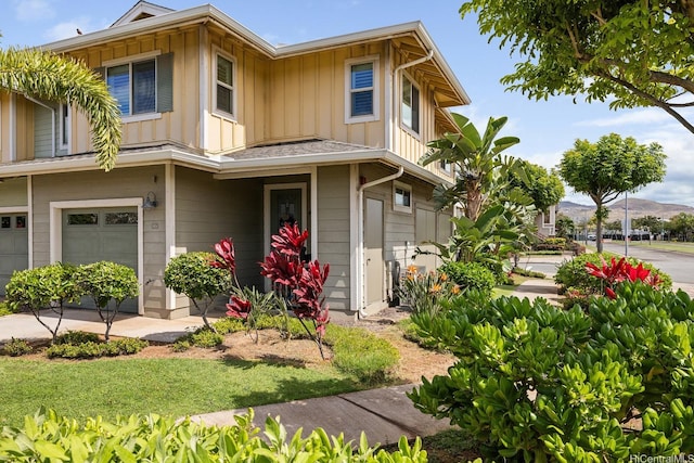 view of front of home with board and batten siding, an attached garage, and concrete driveway