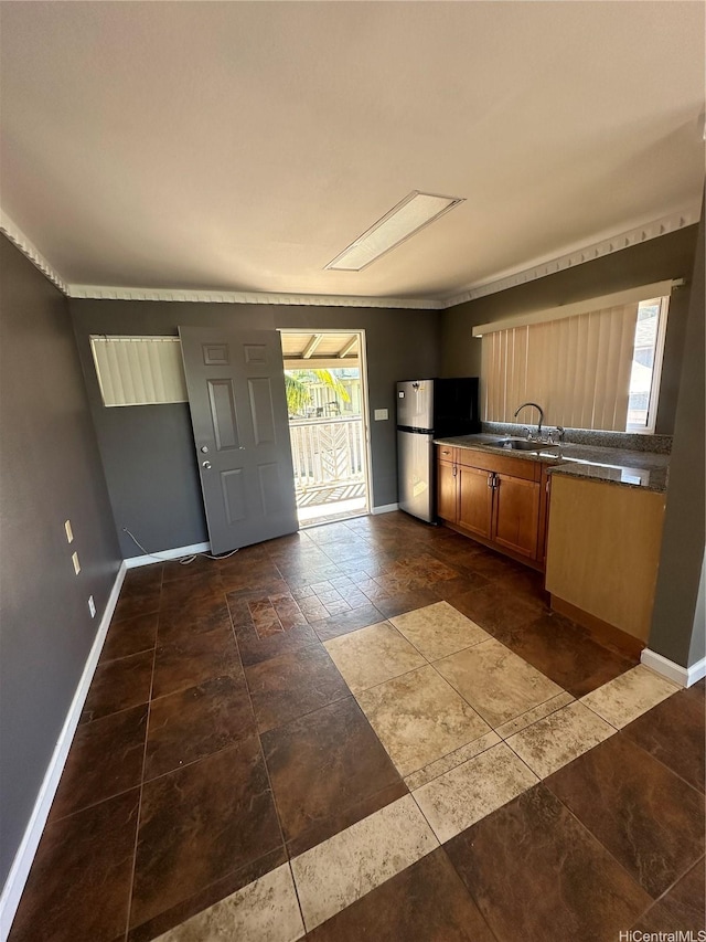 94-065 Waipahu Depot St Unit F, Waipahu, HI 96797 - kitchen with freestanding refrigerator, baseboards, and dark countertops