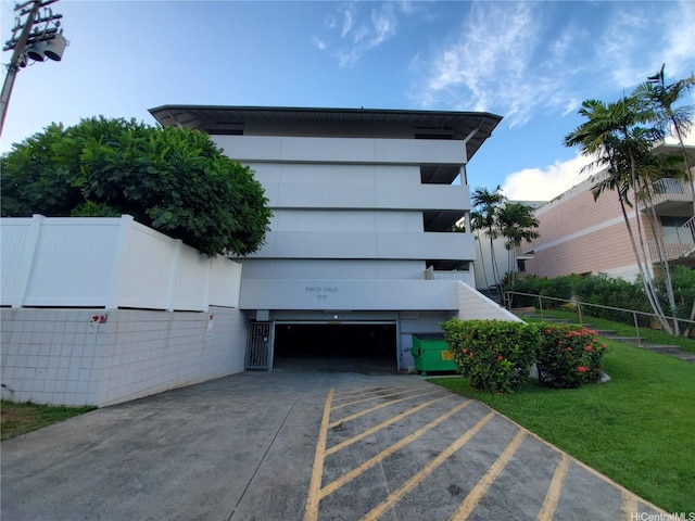 view of front of house with a garage, fence, and driveway