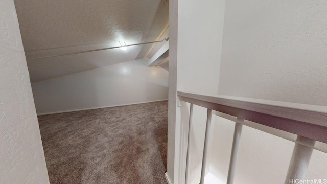 bonus room featuring carpet, a textured wall, and a textured ceiling