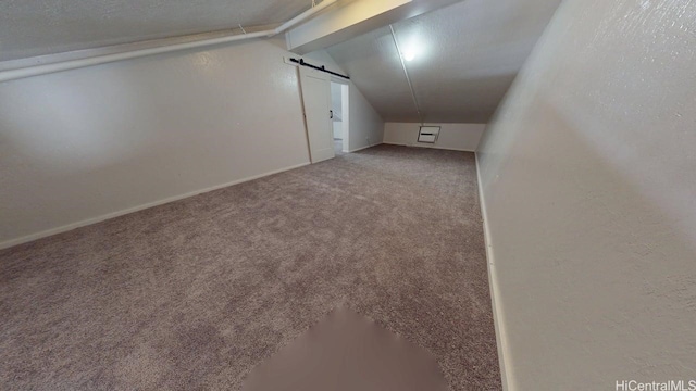 bonus room with lofted ceiling, carpet flooring, and baseboards
