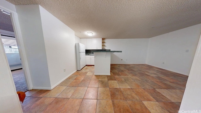 unfurnished room featuring a textured ceiling