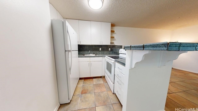kitchen with white appliances, open shelves, backsplash, a breakfast bar, and white cabinetry