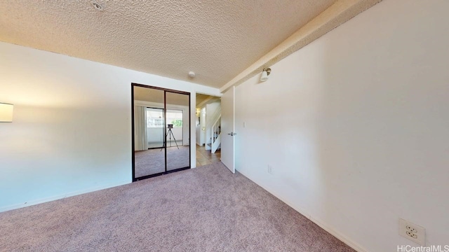 empty room featuring carpet flooring and a textured ceiling
