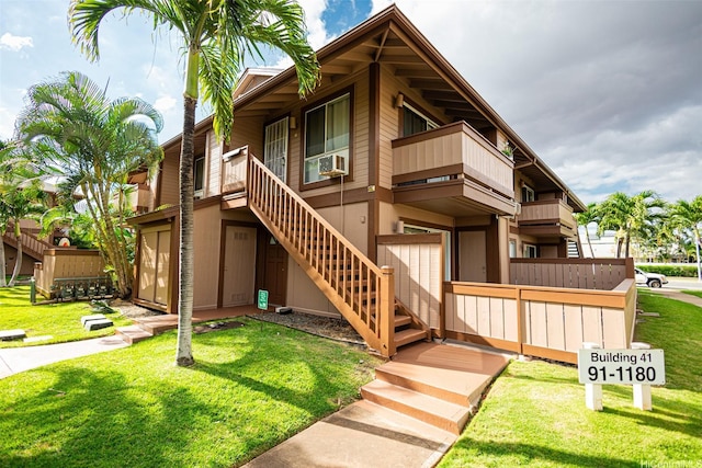 91-1180 Mikohu St Unit 41U, Ewa Beach, HI 96706 - view of front facade featuring stairway, a front lawn, and cooling unit
