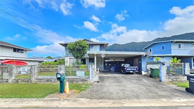 41-532 Kumuhau St, Waimanalo, HI 96795 - view of front of property featuring asphalt driveway, an attached carport, a mountain view, and a fenced front yard