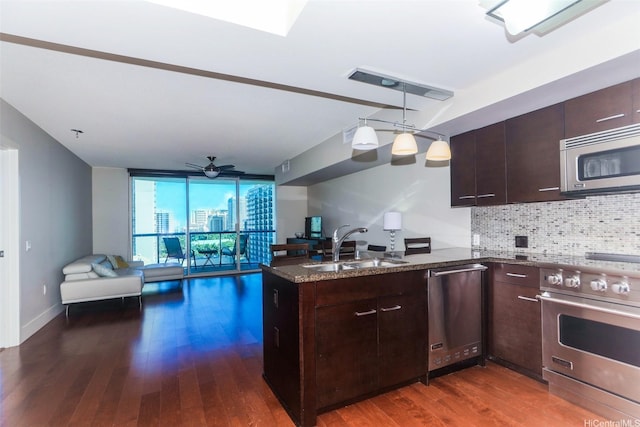 1837 Kalakaua Ave Unit 1102, Honolulu, HI 96815 - kitchen featuring stainless steel appliances, a sink, a peninsula, decorative backsplash, and open floor plan