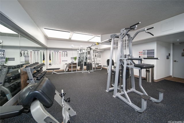 exercise room with a textured ceiling