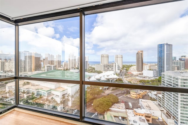 unfurnished sunroom featuring a view of skyline and a water view