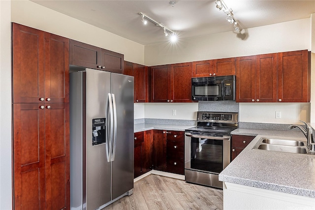1020 Kakala St Unit 914, Kapolei, HI 96707 - kitchen with appliances with stainless steel finishes, a sink, light wood-style flooring, rail lighting, and light countertops