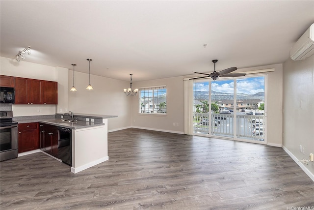 1020 Kakala St Unit 914, Kapolei, HI 96707 - kitchen with black appliances, a peninsula, a wall unit AC, a sink, and a chandelier