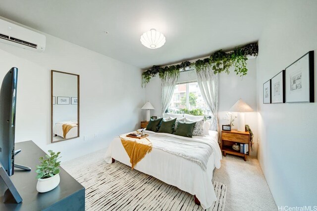 bedroom with a wall mounted AC and carpet floors