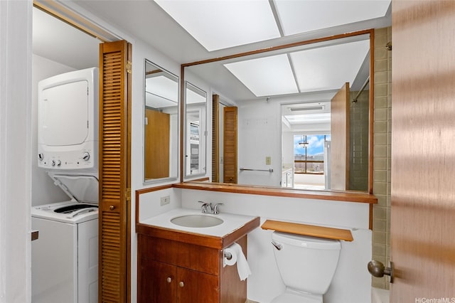 1040 Lunalilo St Unit 706, Honolulu, HI 96822 - bathroom with stacked washing machine and dryer, vanity, and toilet
