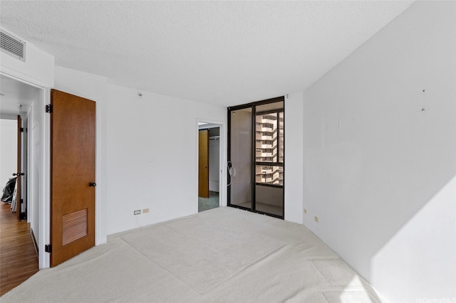 1040 Lunalilo St Unit 706, Honolulu, HI 96822 - carpeted bedroom with a textured ceiling