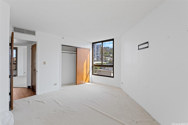 1040 Lunalilo St Unit 706, Honolulu, HI 96822 - unfurnished bedroom with carpet flooring and a closet