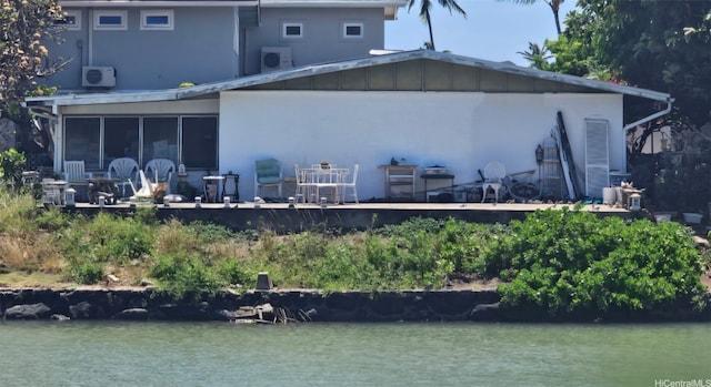 6254 Kawaihae Pl Unit C, Honolulu, HI 96825 - back of property featuring stucco siding, a water view, ac unit, and a sunroom