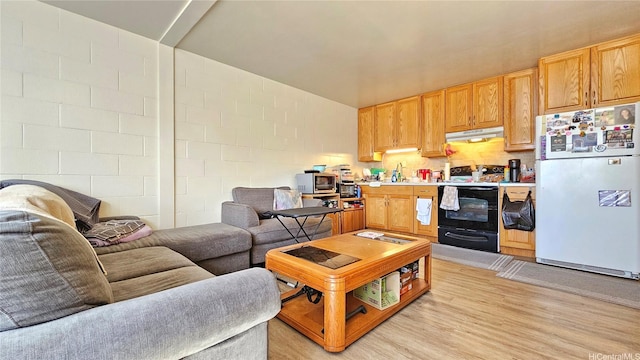 2122 Lime St Unit 307, Honolulu, HI 96826 - living room with light wood-style floors and concrete block wall