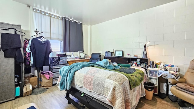 2122 Lime St Unit 307, Honolulu, HI 96826 - bedroom with wood finished floors and concrete block wall