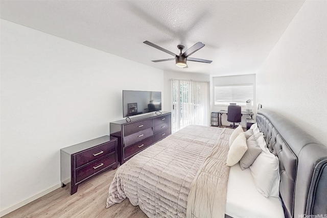 95-270 Waikalani Dr Unit L104, Mililani, HI 96789 - bedroom with light wood finished floors, baseboards, an office area, a ceiling fan, and a textured ceiling