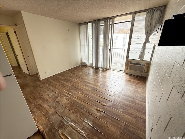 1440 Ward Ave Unit 402, Honolulu, HI 96822 - spare room featuring wood-type flooring, a textured ceiling, and floor to ceiling windows