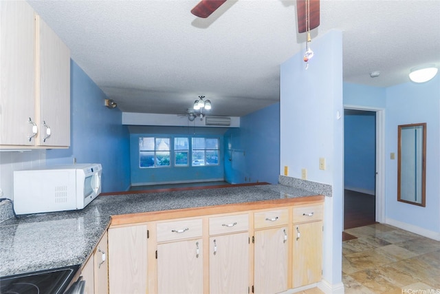 95-1050 Makaikai St Unit 23D, Mililani, HI 96789 - kitchen featuring ceiling fan, white microwave, a textured ceiling, electric range oven, and baseboards