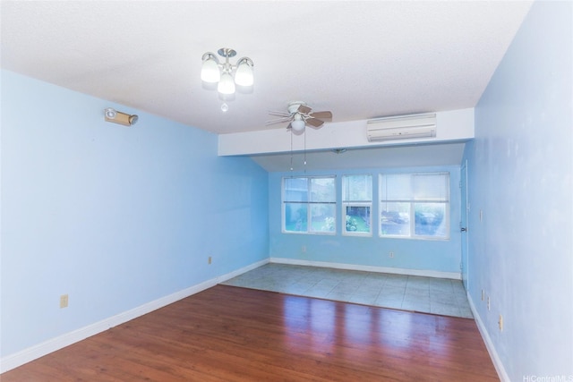95-1050 Makaikai St Unit 23D, Mililani, HI 96789 - unfurnished room with an AC wall unit, wood finished floors, ceiling fan, and baseboards