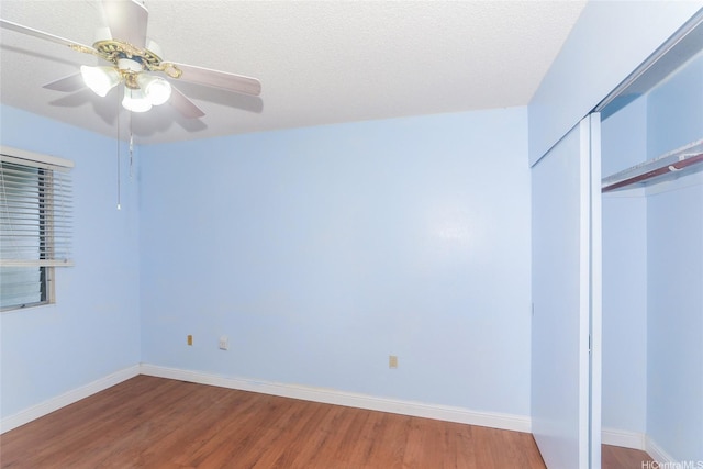 95-1050 Makaikai St Unit 23D, Mililani, HI 96789 - unfurnished bedroom with wood finished floors, a closet, baseboards, and a ceiling fan