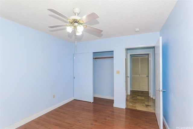 95-1050 Makaikai St Unit 23D, Mililani, HI 96789 - unfurnished bedroom featuring wood finished floors, a closet, baseboards, and a ceiling fan