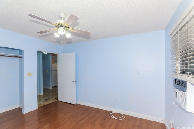 95-1050 Makaikai St Unit 23D, Mililani, HI 96789 - unfurnished bedroom with wood finished floors, baseboards, freestanding refrigerator, and a closet