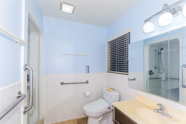 95-1050 Makaikai St Unit 23D, Mililani, HI 96789 - bathroom featuring a shower stall, vanity, toilet, tile walls, and wainscoting