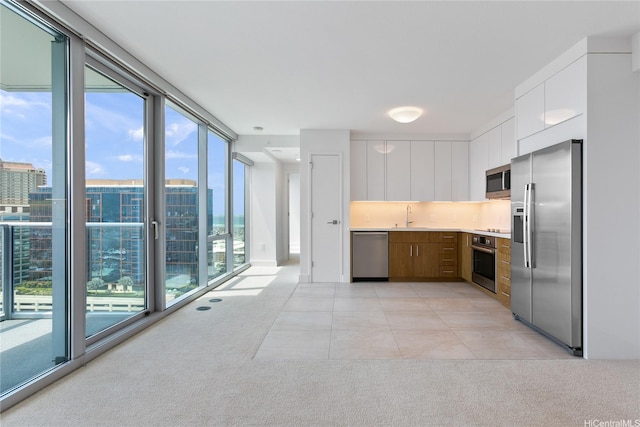 629 Keeaumoku St Unit 2103, Honolulu, HI 96814 - kitchen featuring appliances with stainless steel finishes, a sink, light countertops, and light carpet