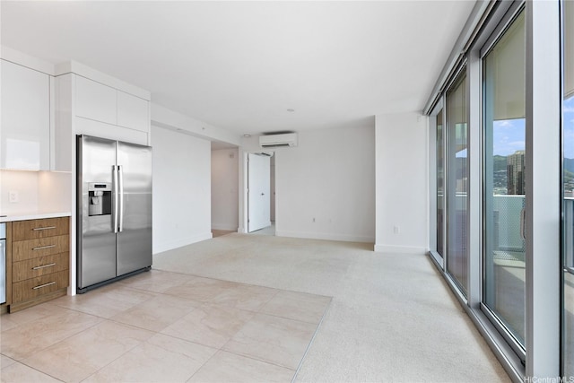 629 Keeaumoku St Unit 2103, Honolulu, HI 96814 - unfurnished living room with a wall mounted air conditioner, baseboards, and light colored carpet