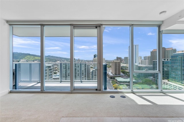 629 Keeaumoku St Unit 2103, Honolulu, HI 96814 - empty room featuring healthy amount of natural light, carpet, a city view, and a smoke detector