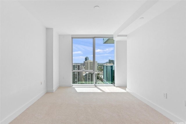 629 Keeaumoku St Unit 2103, Honolulu, HI 96814 - carpeted empty room with floor to ceiling windows, a view of city, and baseboards